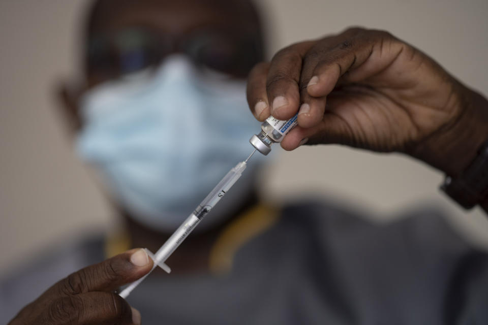 FILE—In this Wednesday, July 28, 2021 file photo, a health worker administers a dose of Janssen COVID-19 vaccine by Johnson & Johnson in the Medina neighborhood in Dakar, Senegal. Thousands of new coronavirus cases have been reported in West Africa in recent weeks amid low vaccination rates and the spread of the delta variant. Officials say cases have risen sharply in Senegal, Ghana, Nigeria and elsewhere. (AP Photo/Leo Correa, File)