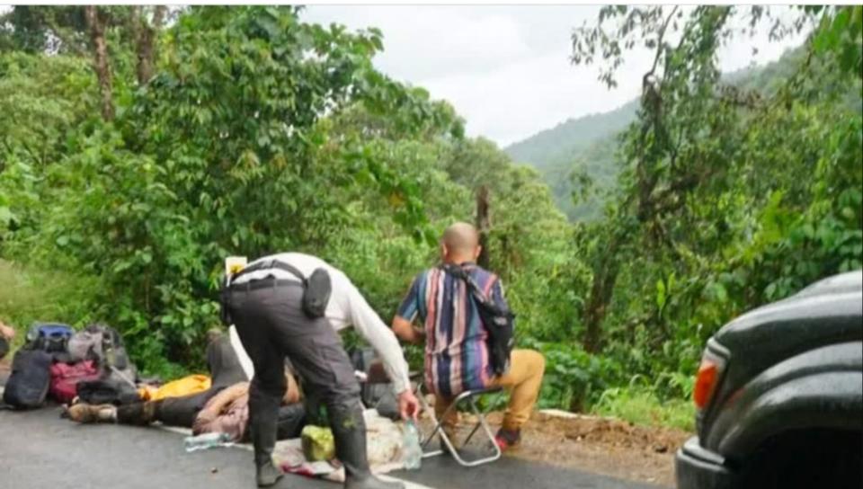 Survivors receiving help after crawling back up the cliff to the roadside. Picture: 9NEWS