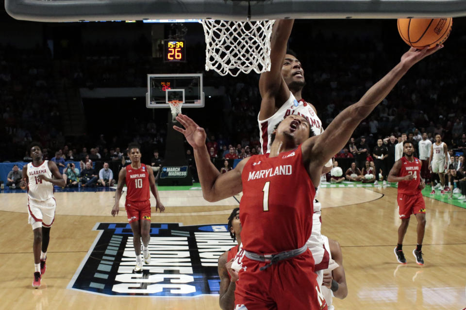 Alabama forward Brandon Miller (24) blocks the shot of Maryland guard Jahmir Young (1) during the second half of a second-round college basketball game in the men's NCAA Tournament in Birmingham, Ala., Saturday, March 18, 2023. (AP Photo/Butch Dill)