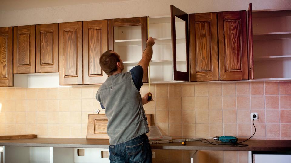 Carpenter working on new kitchen cabinets.