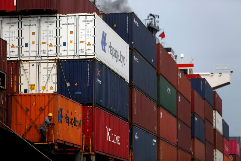 FILE PHOTO: Containers are loaded on a ship at the Acajutla Port in Acajutla