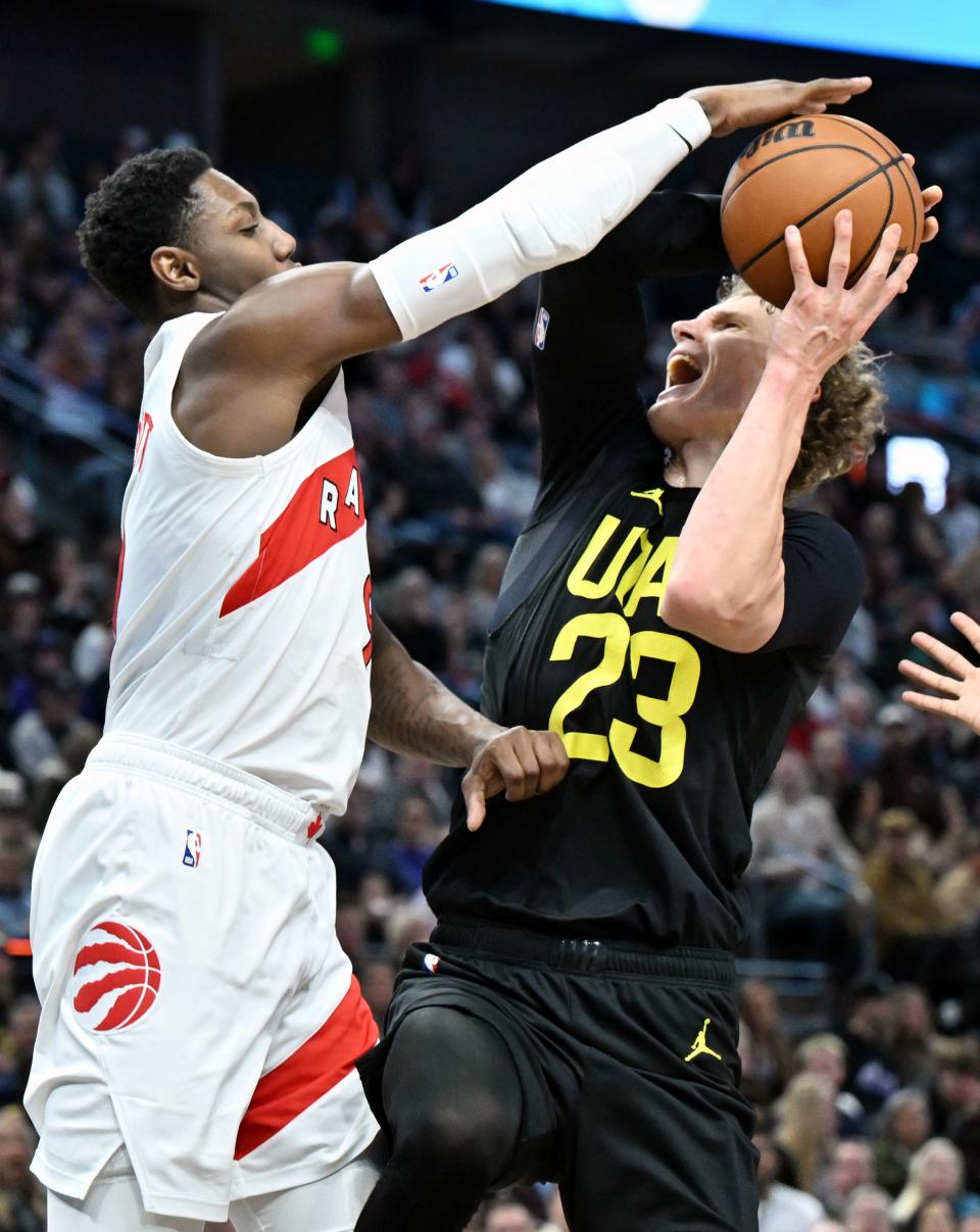 Toronto Raptors guard RJ Barrett (9) tries to defend Utah Jazz forward Lauri Markkanen (23) as the hoop as the Jazz and Raptors play at the Delta Center in Salt Lake City on Friday, Jan. 12, 2024. Utah won 145-113. | Scott G Winterton, Deseret News