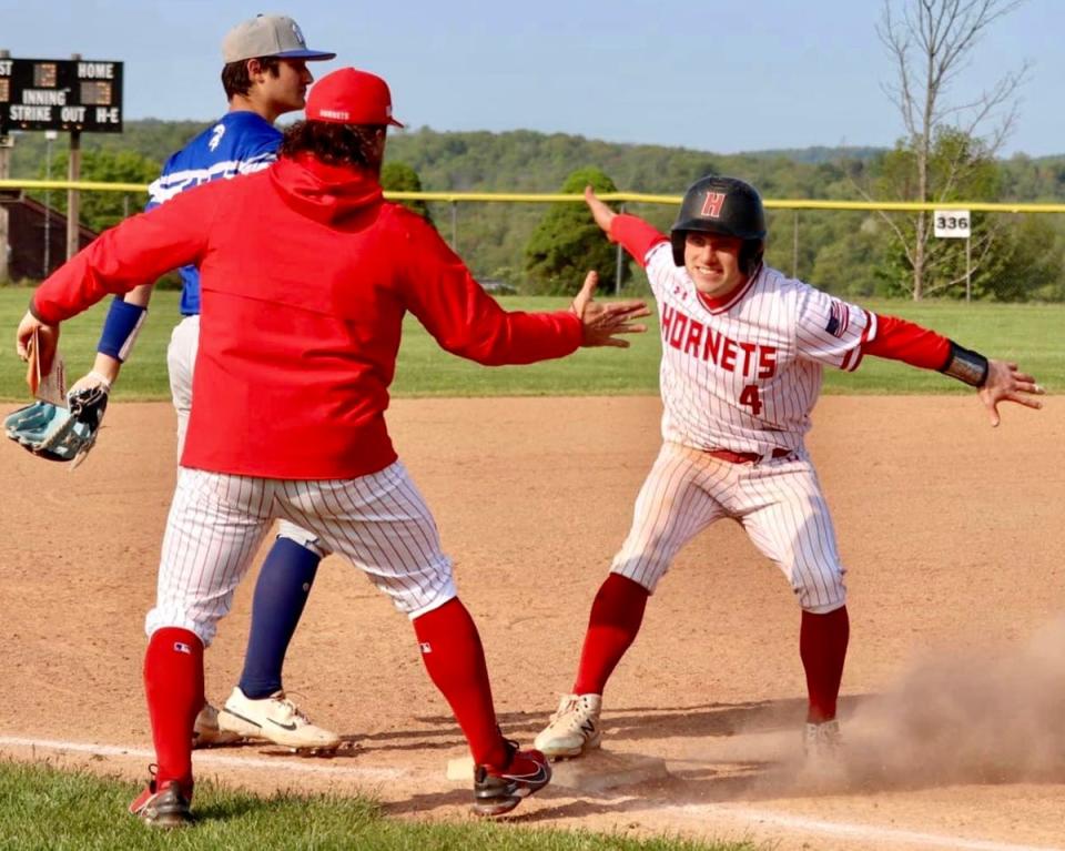 Honesdale's Max Mickel ripped a clutch RBI triple Wednesday against Mid Valley and was greeted gleefully by Head Coach Ernie Griffis at third base.