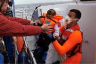 A migrant baby is taken off the Sea-Watch 3 rescue ship on Wednesday after spending weeks stranded at sea