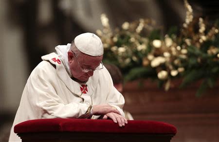 Pope Francis prays during the Christmas night mass in the Saint Peter's Basilica at the Vatican