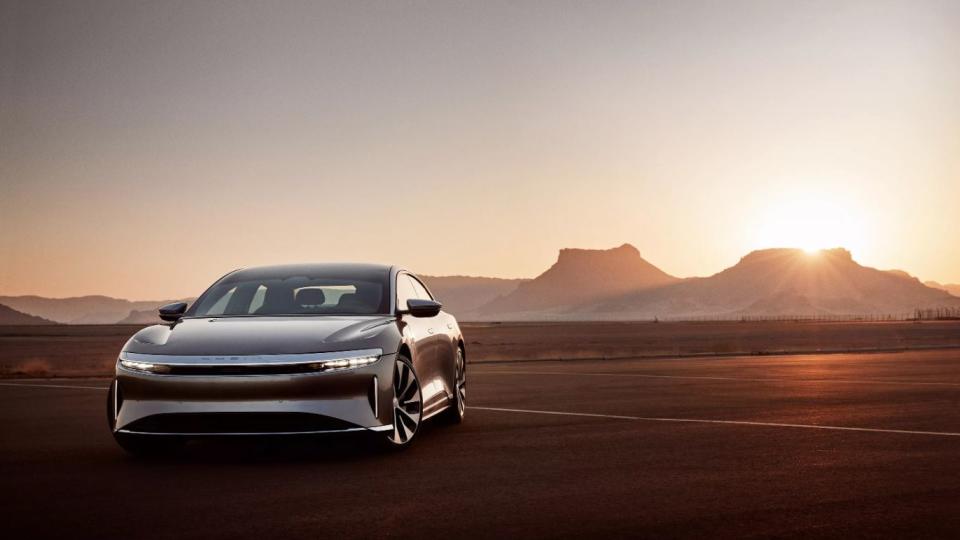 a car on a road with mountains in the background