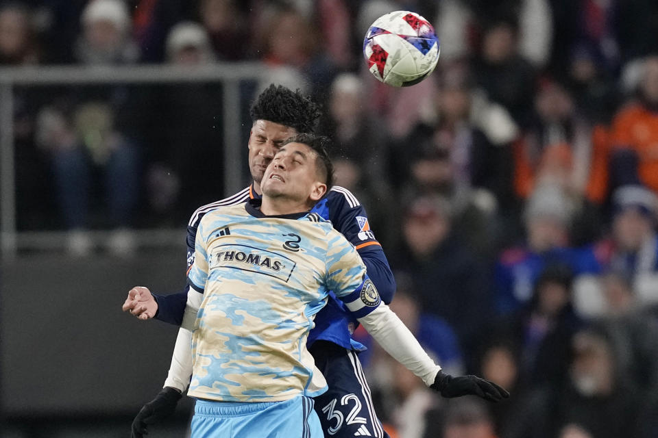 Philadelphia Union midfielder Alejandro Bedoya (11) and FC Cincinnati defender Ian Murphy (32) go up to head the ball during the first half of an MLS Eastern Conference semifinals playoff soccer match Saturday, Nov. 25, 2023, in Cincinnati. (AP Photo/Carolyn Kaster)