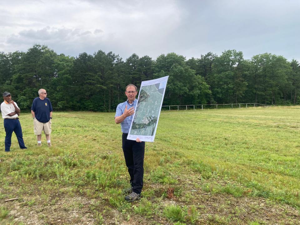 Massachusetts Army National Guard Natural Resources and Training Lands Manager Jake McCumber gives a presentation to a tour group on Joint Base Cape Cod at the site of the proposed machine gun range on Camp Edwards June 18, 2023.
