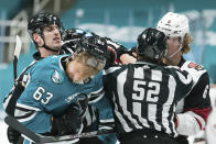 San Jose Sharks left wing Jeffrey Viel (63) and Arizona Coyotes defenseman Jakob Chychrun (6) fight during the first period of an NHL hockey game in San Jose, Calif., Saturday, May 8, 2021. (AP Photo/John Hefti)