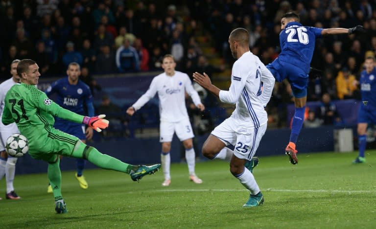 Leicester City's Riyad Mahrez (R) shoots past FC Copenhagen's goalkeeper Robin Olsen (L) to scores his team's first goal during at the King Power Stadium in Leicester, central England on October 18, 2016