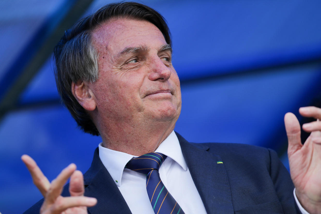 Brazilian President Jair Bolsonaro exits a convention center in Brasilia, Brazil, November 30, 2021, after attending a ceremony where he officially joined the centrist Liberal Party. / Credit: Raul Spinasse/AP