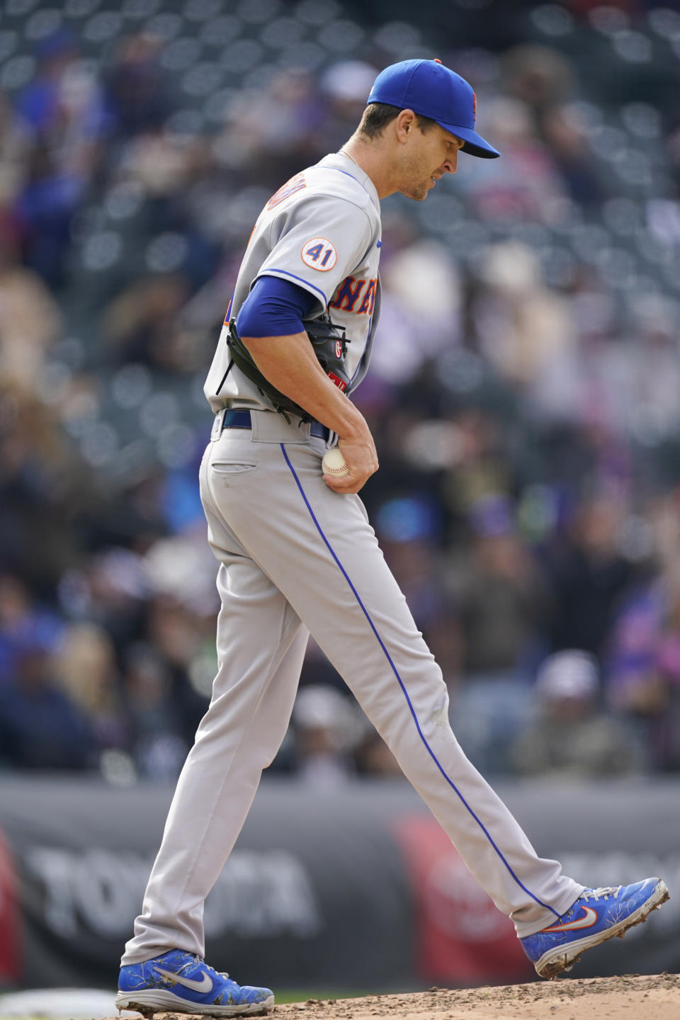 New York Mets starting pitcher Jacob deGrom reacts after giving up a solo home run to Colorado Rockies' Raimel Tapia during the fifth inning of the first baseball game of a doubleheader Saturday, April 17, 2021, in Denver. (AP Photo/David Zalubowski)