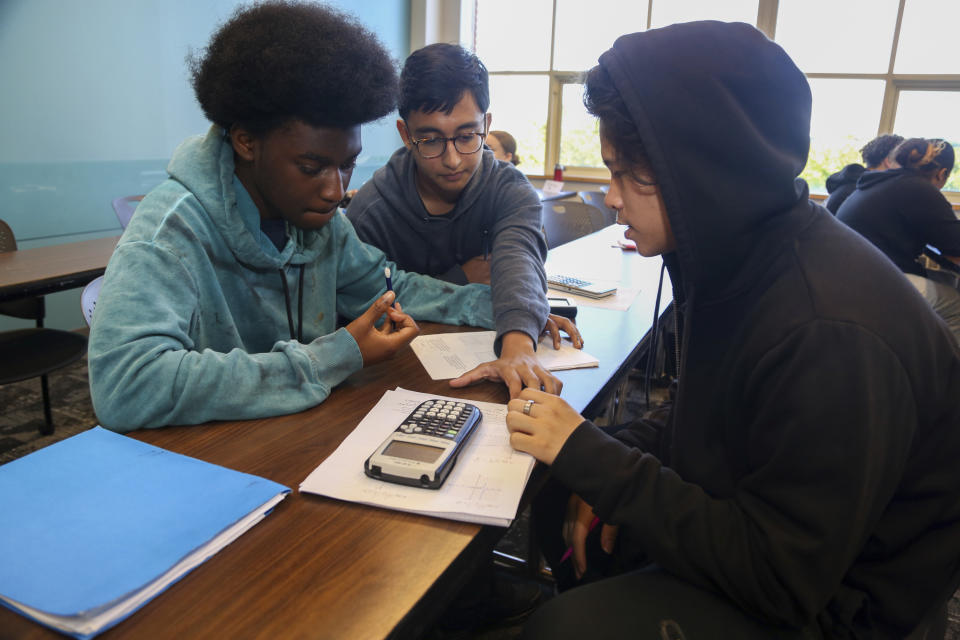 From left, Jason Burrell, 17; Rishan Zaman, 16, and Brian Lam, 16, work together in a pre-calculus class during the Bridge to Calculus summer program at Northeastern University in Boston on Tuesday, Aug. 1, 2023. Ten years after graduating, math majors out-earn graduates in other fields by about 17 percent, according to an analysis by the Burning Glass Institute using the education and job histories of more than 50 million workers. (AP Photo/Reba Saldanha)