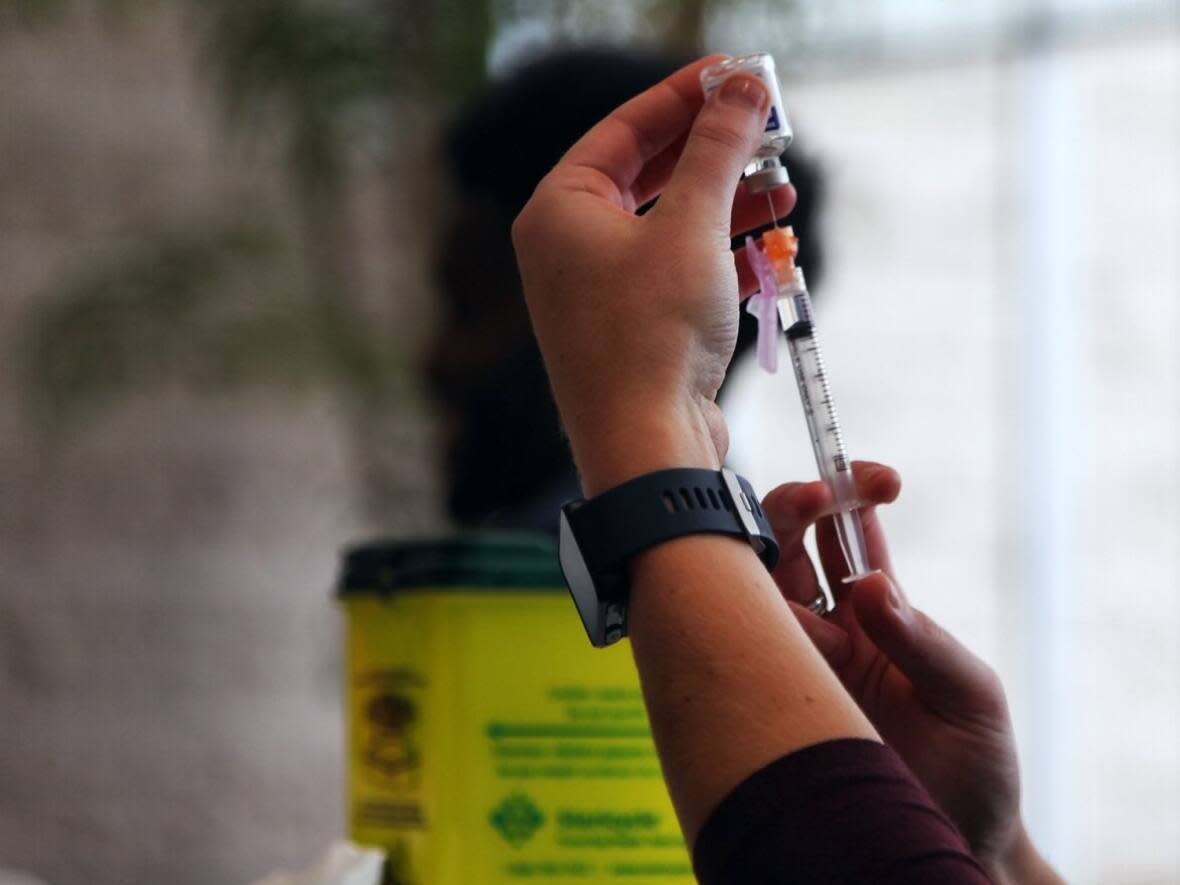 Flu shots are available in Ontario for those six months of age and up. The province is encouraging people to get COVID-19 boosters too.  (Stu Mills/CBC - image credit)