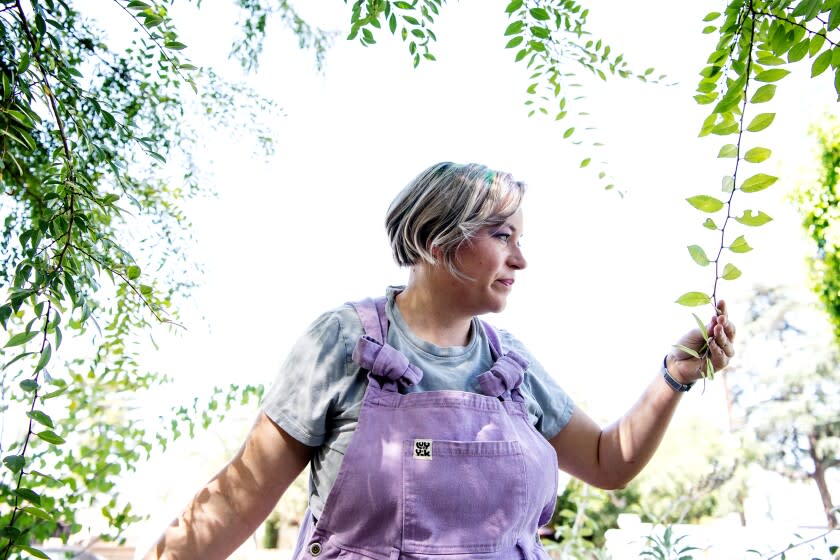 ALTADENA, CA - JUNE 27: Portrait of Seriina Covarrubias at her home in Altadena on Monday, June 27, 2022 in Altadena, CA. Covarrubias replaced her once green lawn with California natives, a stone pond water catchment area and an array of drought tolerant plants. (Mariah Tauger / Los Angeles Times)