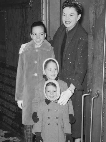 <p>Bettmann</p> Judy Garland poses with her three children, Liza Minelli, Lorna Luft, and Joey Luft at Grand Central Station.