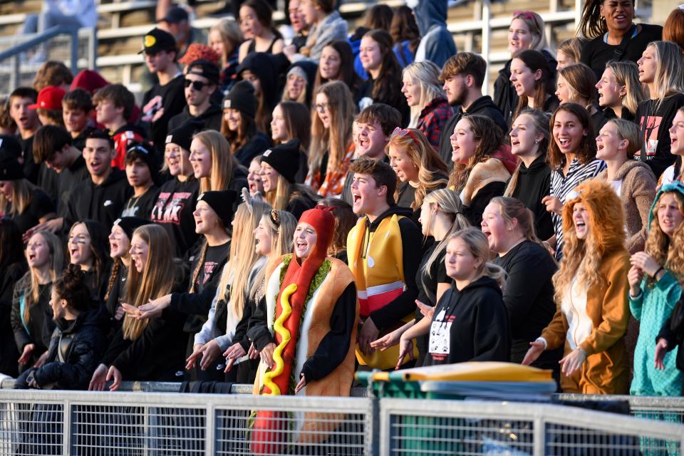 Brandon Valley students, including a few in costume ahead of the week of Halloween, cheer during a football game on Thursday, October 20, 2022, at Howard Wood Field in Sioux Falls.
