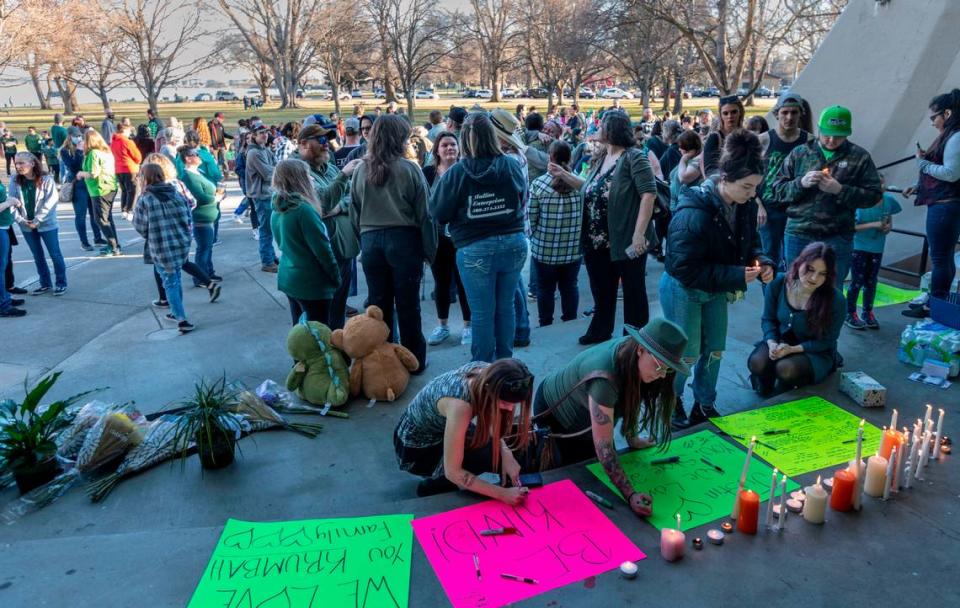 After a brief ceremony celebrating Justin Krumbah’s life, people took turns writing messages on posters and lighting candles in remembrance of the Instacart worker who was shot inside the Richland Fred Meyer. About 300 gathered in Howard Amon Park.