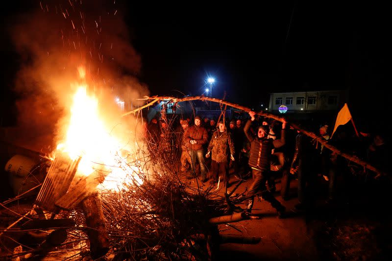 Demonstrators protest the arrival of evacuees from China in Poltava region