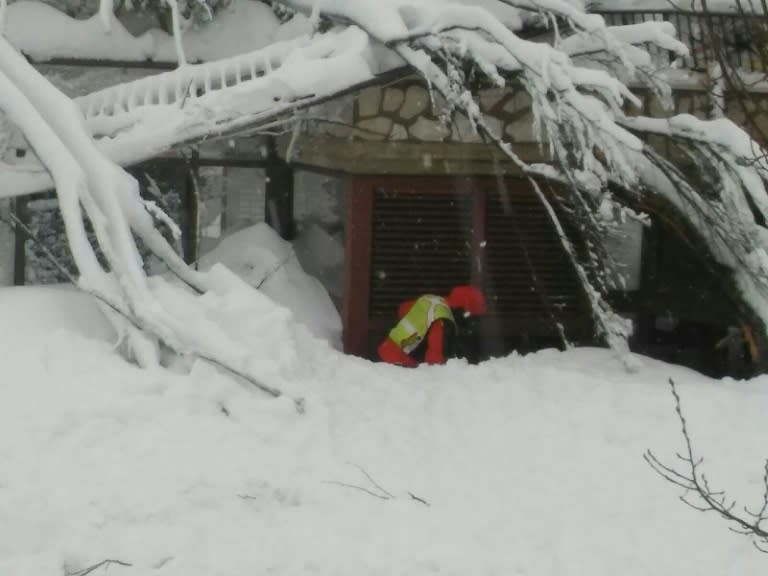 A rescuer digging at the avalanche-hit Hotel Rigopiano, near the village of Farindola, on the eastern lower slopes of the Gran Sasso mountain on January 19, 2017