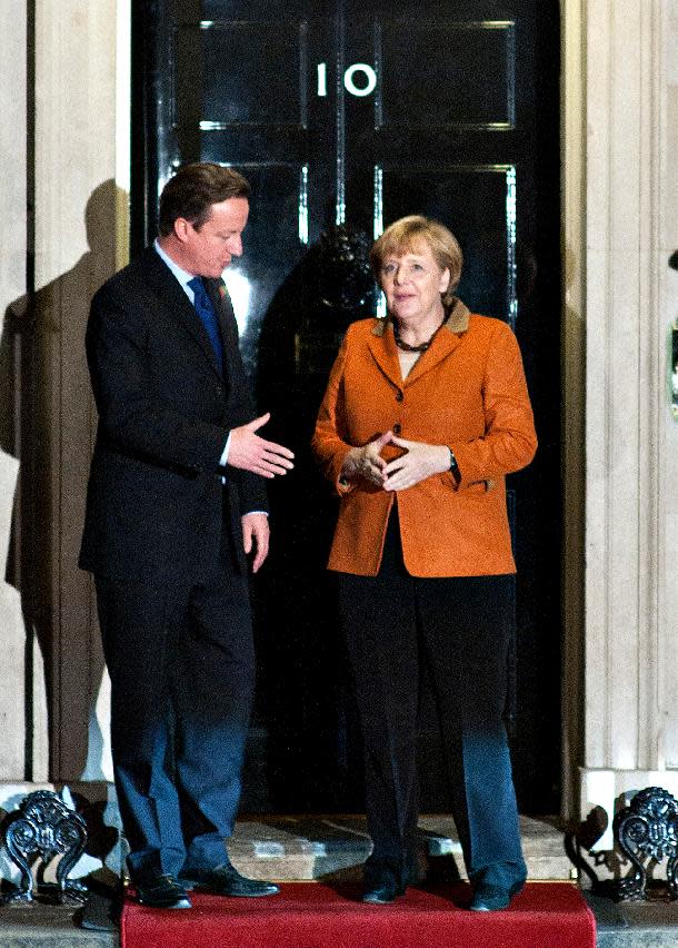 Britain's Prime Minister David Cameron, left, goes to shake hands with German Chancellor Angela Merkel, right, as they pose for the media before their meeting at 10 Downing Street, in London, Wednesday, Nov. 7, 2012. The Prime Minister said at a recent EU summit in Brussels that he would veto any proposal for the next seven-year budget framework that went above a freeze on the current position, this, in turn, allegedly left the German Chancellor prepared to scupper a summit of European leaders due on 22-23 November on the EU budget unless David Cameron withdraws the threat of a blanket veto. (AP Photo/Bogdan Maran)