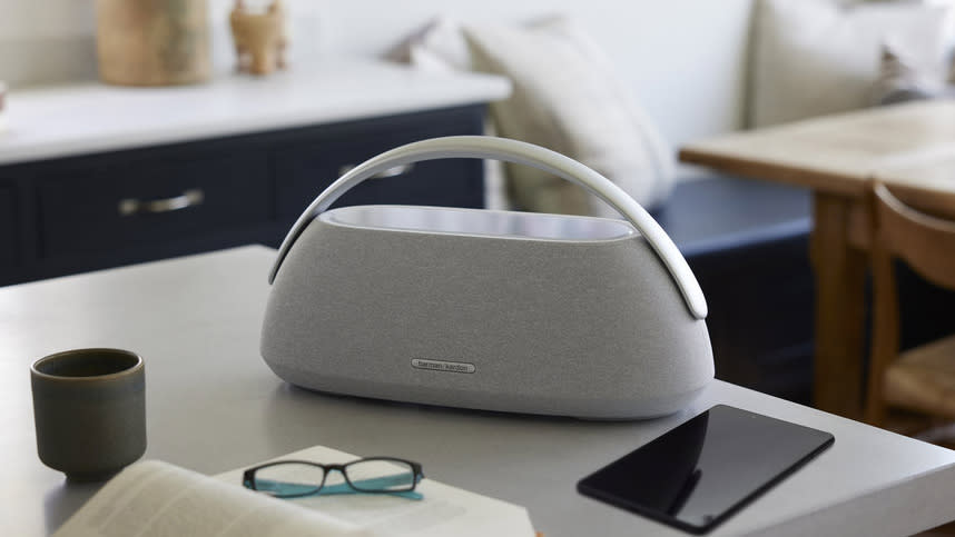 Harman Kardon Go+Play 3 on a table with a book