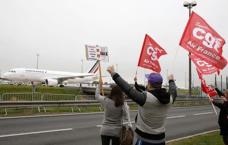 Striking employees of Air France demonstrate in front of the Air France headquarters building at the Charles de Gaulle International Airport in Roissy, near Paris, France, October 5, 2015. REUTERS/Jacky Naegelen