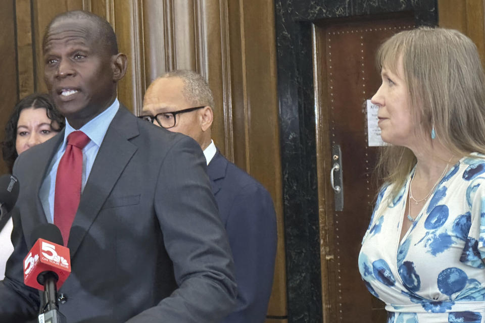 St. Louis Circuit Attorney Gabe Gore, left, speaks at a news conference on Tuesday, July 23, 2024, in St. Louis, after a judge overturned the murder conviction of Christopher Dunn. At right is Dunn’s wife, Kira. (AP Photo/Jim Salter)