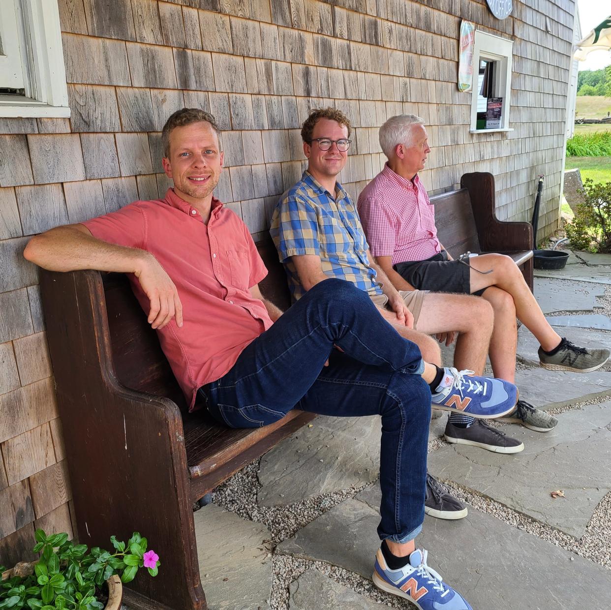 From left to right Conor Guptill, his brother Aram and their father Michael, sit outside the box office at Hackmatack Playhouse in Berwick.