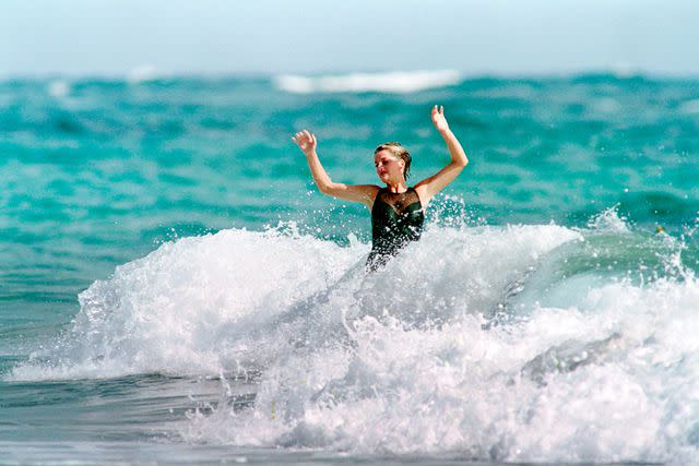 <p> PAUL J. RICHARDS/AFP/getty</p> Princess Diana splashes in Nevis in 1993.