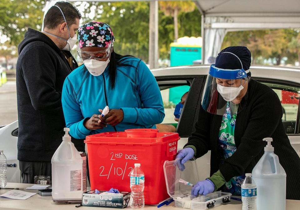 Nurses prepare COVID-19 vaccine shots for Miami-Dade County residents with appointments at Tropical Park in Miami on Wednesday, Jan. 13, 2021.