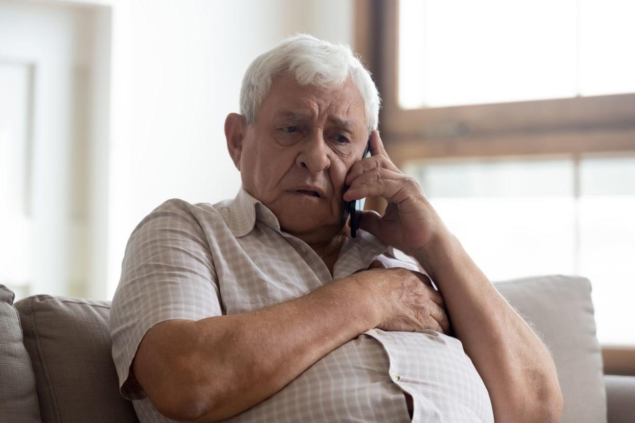 senior man talking on phone stressed