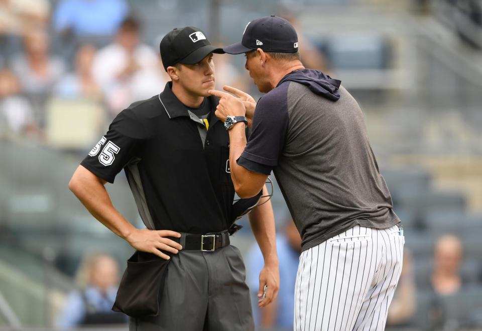 NEW YORK, NEW YORK - JULY 18: Manager Aaron Boone #17 of the New York Yankees argues with home plate umpire Brennan Miller #55 during the second inning of game one of a doubleheader against the Tampa Bay Rays at Yankee Stadium on July 18, 2019 in the Bronx borough of New York City. (Photo by Sarah Stier/Getty Images)