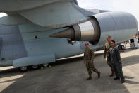 U.S. Air Force pilots based in England look on a Japan Kawasaki C-2 tactical military transport aircraft at Paris Air Show, in Le Bourget, north east of Paris, France, Tuesday, June 18, 2019. The world's aviation elite are gathering at the Paris Air Show with safety concerns on many minds after two crashes of the popular Boeing 737 Max. (AP Photo/ Francois Mori)