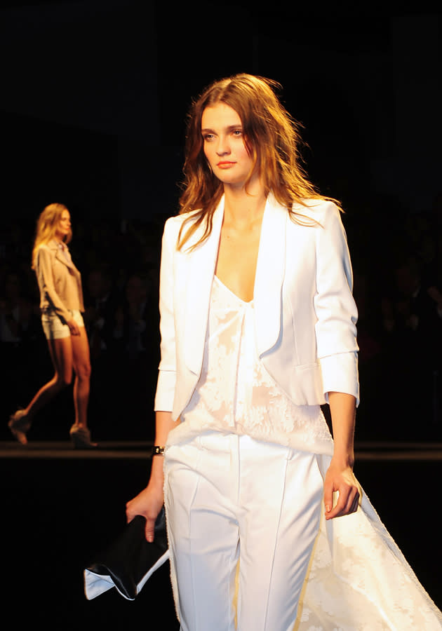 The Mango AW13 collection featured a striking lace blouse with a huge train, teamed with a tailored white suit.<br><br>©WENN