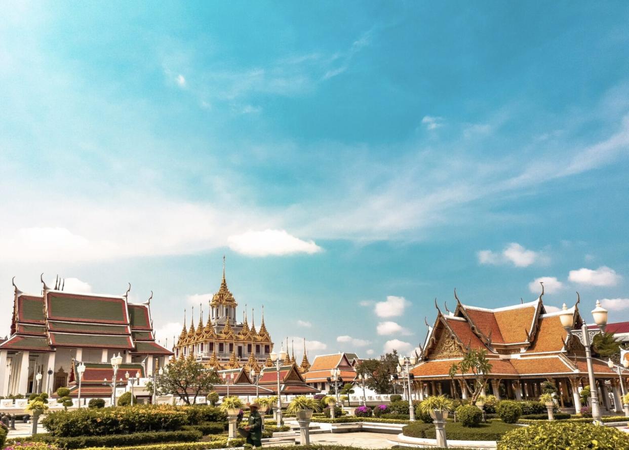 Thailand is a pretty safe place to visit. Check out what makes it a nice destination and how travelers can stay secure. Pictured: the temples and historic buildings of Thailand on a bright blue day