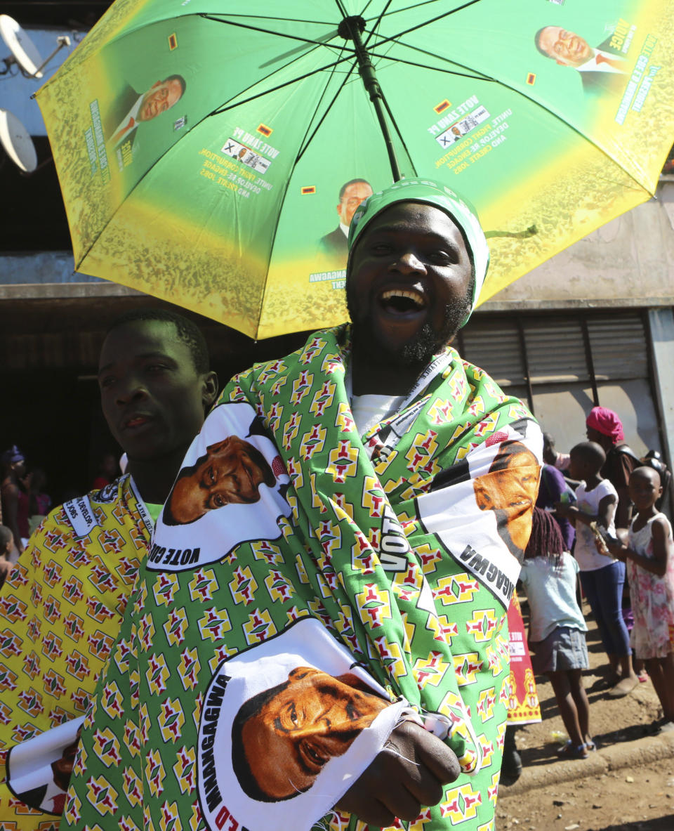 Supporters of Zimbabwe's President Emmerson Mnangagwa celebrate in Harare, Friday, Aug, 3, 2018. Mnangagwa won an election Friday with just over 50 percent of the ballots as the ruling party maintained control of the government in the first vote since the fall of longtime leader Robert Mugabe. (AP Photo/Tsvangirayi Mukwazhi)