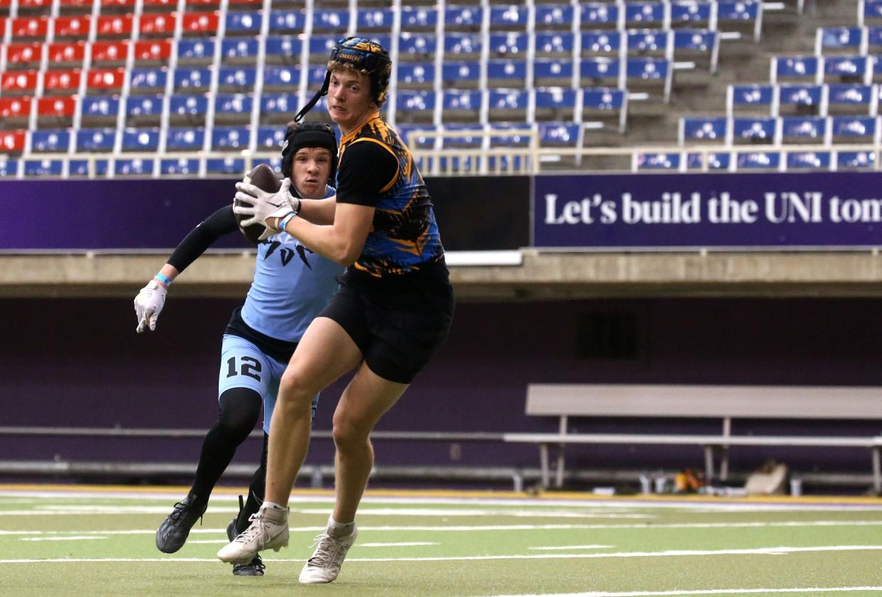 Jaxx DeJean turns to run after catching a pass during a 7-on-7 football tournament Saturday at the UNI Dome in Cedar Falls.
