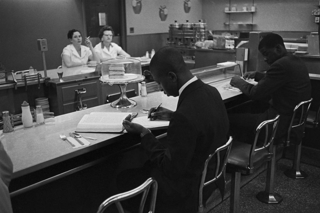 PHOTO: African American students from Saint Augustine College study while participating in a sit-in at a lunch counter reserved for white customers in Raleigh, NC, Feb. 10, 1960. (Bettmann Archive)