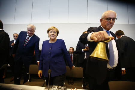 German Chancellor Angela Merkel, leader of the Christian Democratic Union Party (CDU) and Horst Seehofer, head of the CSU and Bavarian premier attend their first parliamentary meeting after the general election in Berlin, Germany September 26, 2017. REUTERS/Fabrizio Bensch