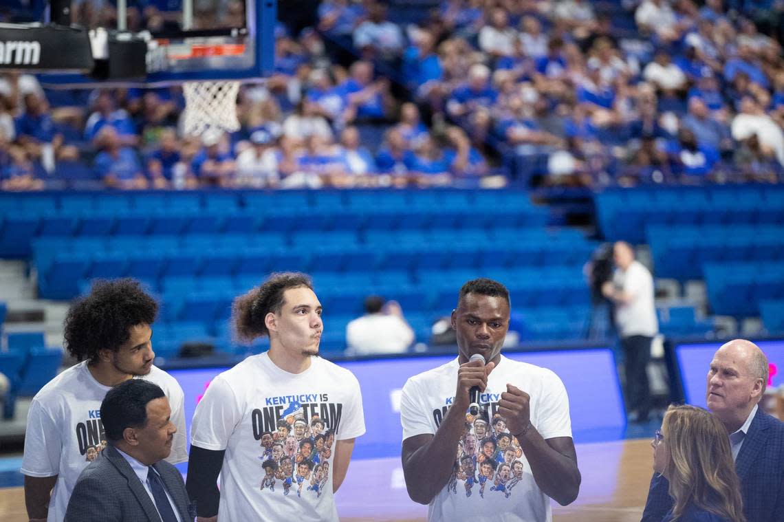 Jacob Toppin, left, Lance Ware, center, and Oscar Tshiebwe talk from the Rupp Arena court during the telethon for Eastern Kentucky flood victims Tuesday night.