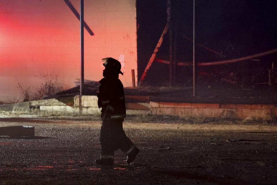 A Selma firefighter walks back the the truck after putting out a fire that started from a tornado that passed through downtown Selma, Ala., Thursday, Jan. 12, 2023. (AP Photo/Butch Dill)