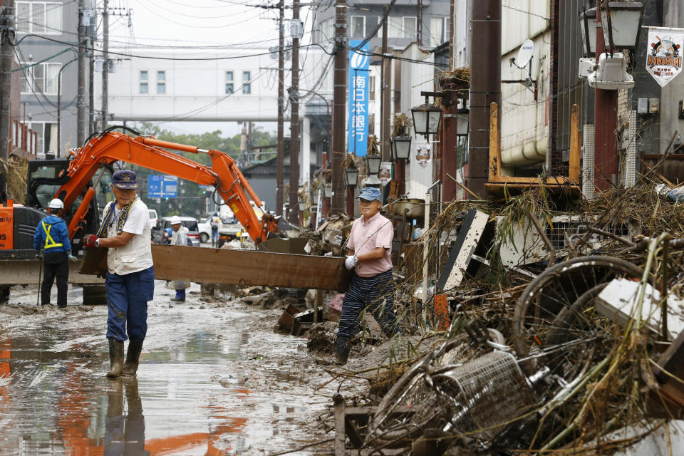 People work for recovery efforts as the city was affected by a heavy rain in Hitoyoshi, Kumamoto prefecture, southern Japan Thursday, July 9, 2020. Pounding rain spread to central Japan and triggered mudslides. (Kenzaburo Fukuhara/Kyodo News via AP)