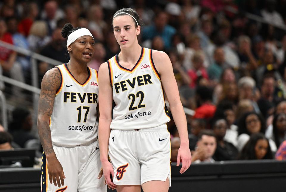 Inddiana Fever guards Erica Wheeler (17) and Caitlin Clark (22) look on during Friday night's game against the Atlanta Dream.