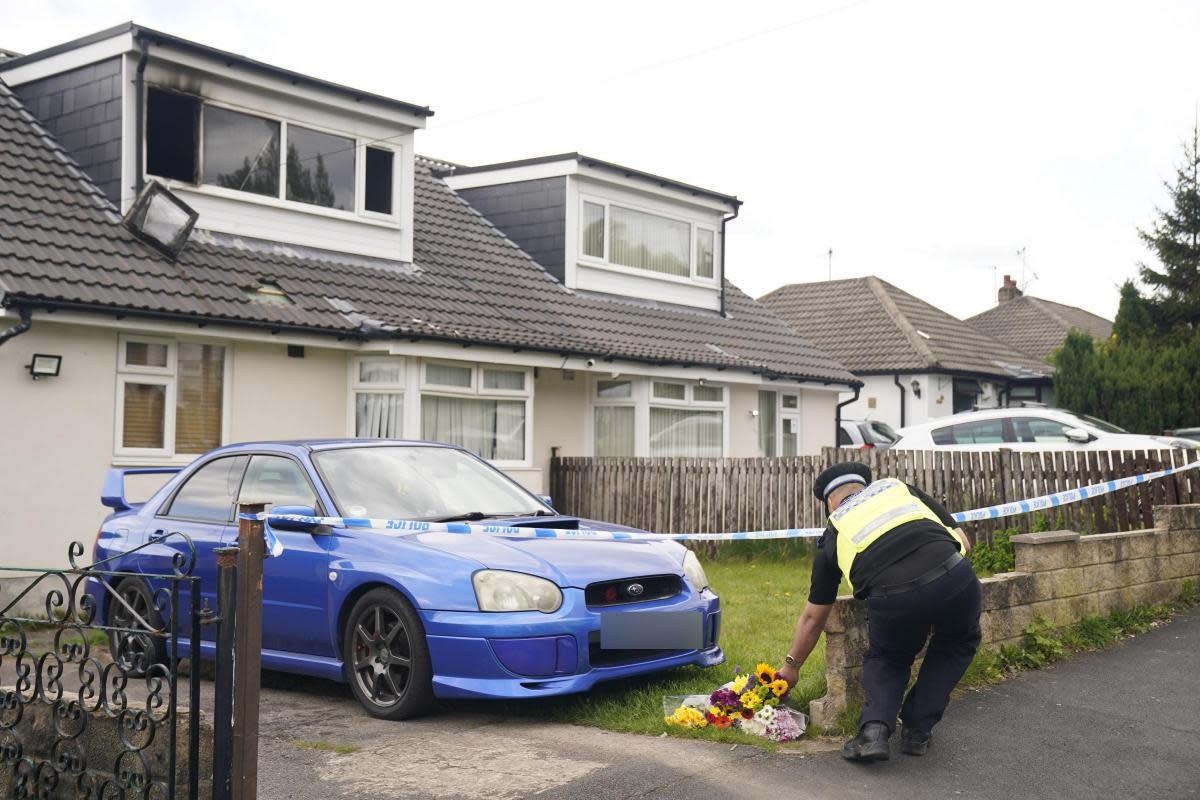 A police officer at the scene of a fatal house fire in Bradford, where one child has died and four other people were taken to hospital. <i>(Image: PA)</i>