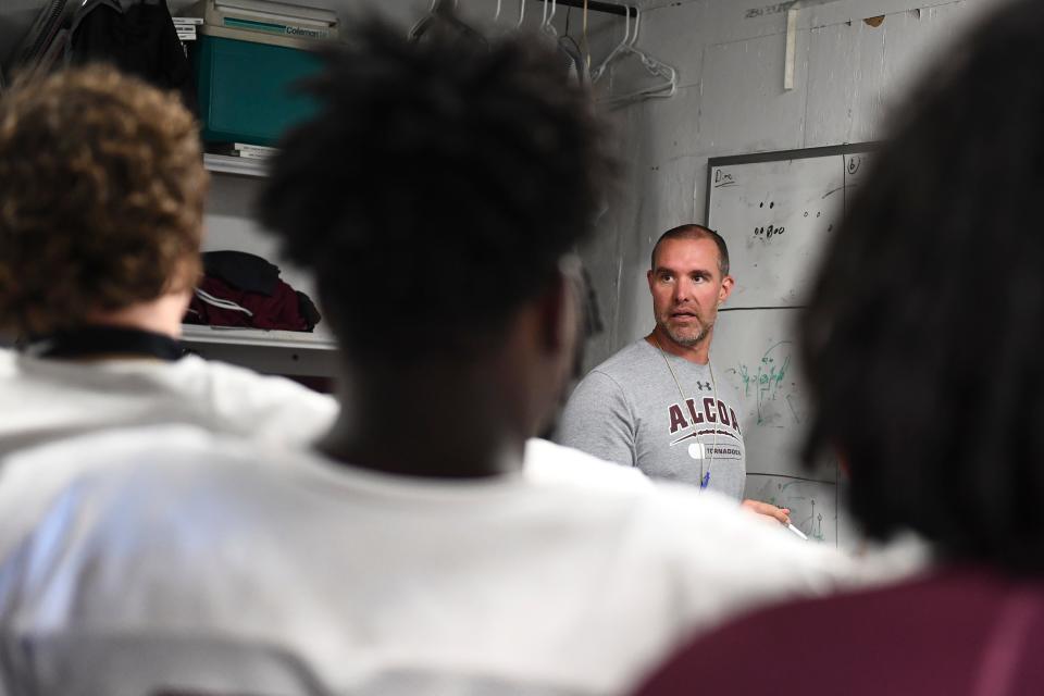 Alcoa High School football coach Brian Nix talks meets with the linebackers before the start of practice on Monday, July 25, 2022. 