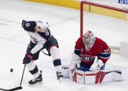 Montreal Canadiens goaltender Cayden Primeau (30) makes a save as Columbus Blue Jackets' Dmitri Voronkov (10) looks for the puck during the first period of an NHL hockey game Tuesday, March 12, 2024, in Montreal. (Christinne Muschi/The Canadian Press via AP)