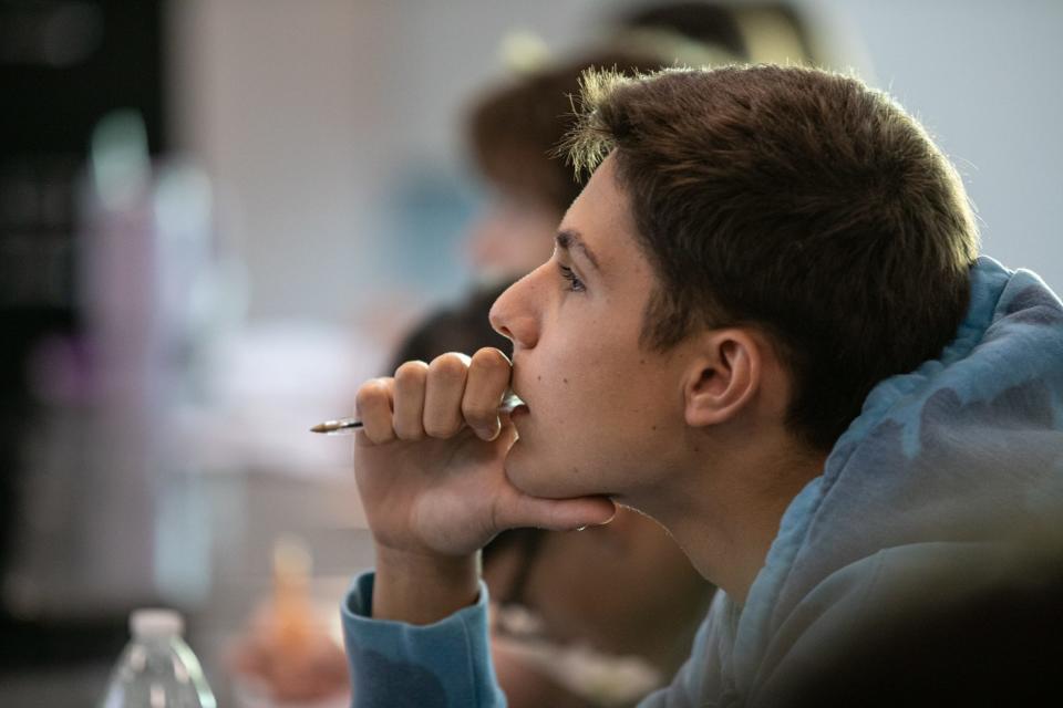 Carroll High School junior Gabrielle Maccarone, 17, chews on the tip of a pin while he listens to a lecture during an AP U.S. history class on Wednesday, Oct. 18, 2023, in Corpus Christi, Texas.