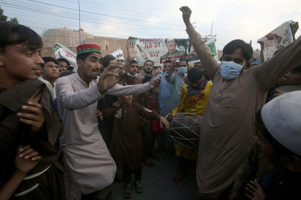 Supporters of Pakistan's former Prime Minister Imran Khan dance to celebrate after Supreme Court decision, in Peshawar, Pakistan, Thursday, May 11, 2023. Pakistan’s Supreme Court has ordered the release of Khan, whose arrest earlier this week sparked a wave of violence across the country by his supporters. (AP Photo/Muhammad Sajjad)