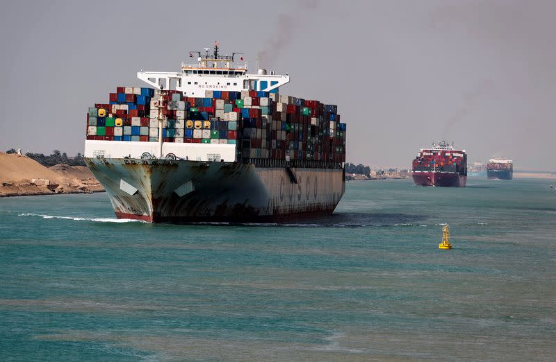 FILE PHOTO: Shipping containers pass through the Suez Canal in Suez